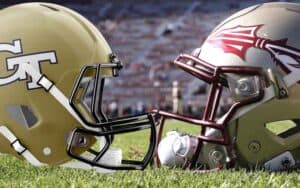Seminoles and Yellow Jackets helmets facing each other on a football field