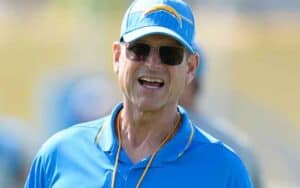 Jim Harbaugh with an LA Chargers hat on