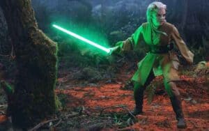 Jecki Lon of The Acolyte holding a light saber
