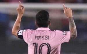Lionel Messi pointing toward the sky