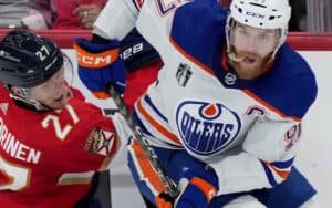 An Oilers and a Panthers player battling on the ice