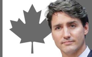 Justin Trudeau in front of a black and white Canadian flag