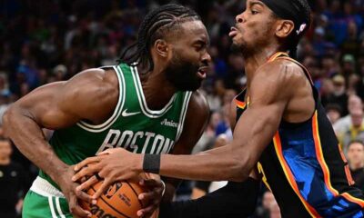 players for the Boston Celtics and Oklahoma City Thunder fighting for the ball