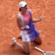 Iga Swiatek celebrating by falling to her knees on the clay courts of the French Open
