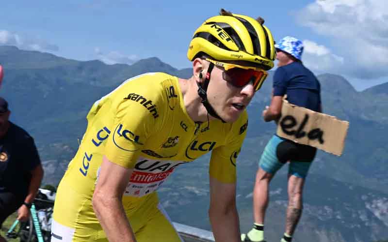 Tadej Pogacar racing in the 2025 tour de France