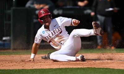 an Arkansas Baseball player sliding
