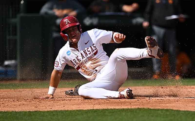an Arkansas Baseball player sliding