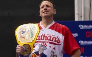 Joey Chestnut weawring a Hot Dog Eating Championship belt