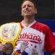 Joey Chestnut weawring a Hot Dog Eating Championship belt