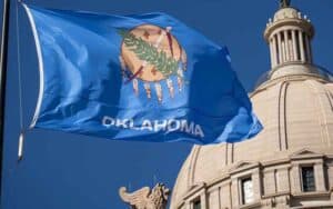 The Oklahoma flag flying in front of the state legislature