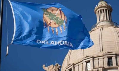 The Oklahoma flag flying in front of the state legislature