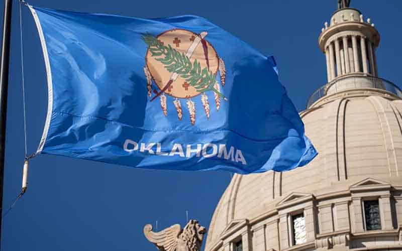 The Oklahoma flag flying in front of the state legislature