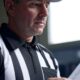 An NFL referee reading new NFL rules