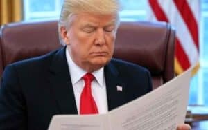 President Trump reading the Big Beautiful Bill in the Oval Office