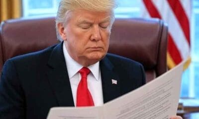 President Trump reading the Big Beautiful Bill in the Oval Office