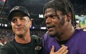 Lamar Jackson and Jim Harbaugh walking off the field together