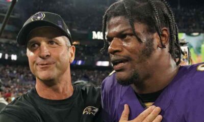 Lamar Jackson and Jim Harbaugh walking off the field together