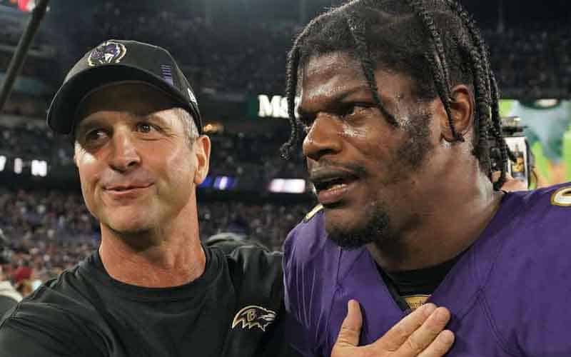 Lamar Jackson and Jim Harbaugh walking off the field together