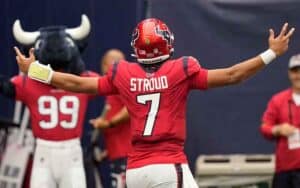 CJ Stroud with his arms outstreched facing away from camera