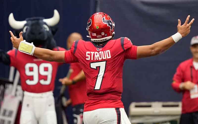 CJ Stroud with his arms outstreched facing away from camera