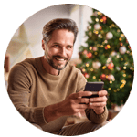a guy betting on an NFL sportsbook app next to a Christmas tree