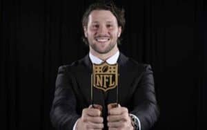 Josh Allen holding an NFL MVP Award