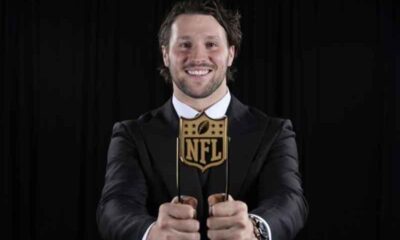 Josh Allen holding an NFL MVP Award