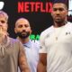 Jake Paul and Anthony Joshua posing for the cameras at the pre-fight press conference