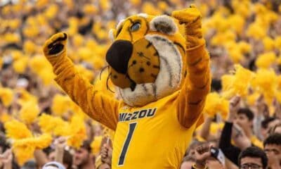 The University of Missouri's mascot Truman the Tiger cheering alongside fans