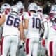 A New England Patriots huddle led by Drake Maye