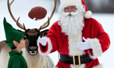 Santa throwing a football to an elf while a reindeer watches