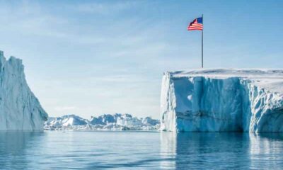 Greenland with a US flag planted into a glacier