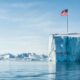 Greenland with a US flag planted into a glacier