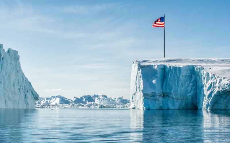 Greenland with a US flag planted into a glacier
