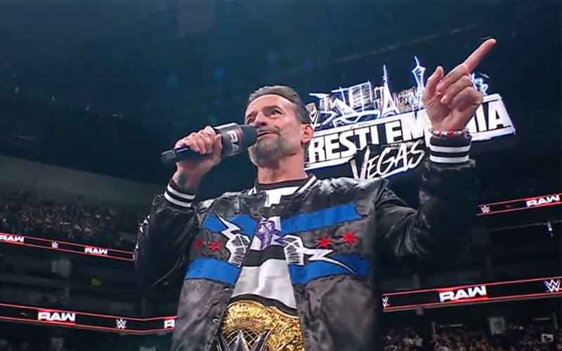 CM Punk cutting a promo in front of a WrestleMania Vegas sign at RAW
