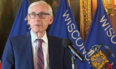WI Gov. Evers speaking to the press at his official podium