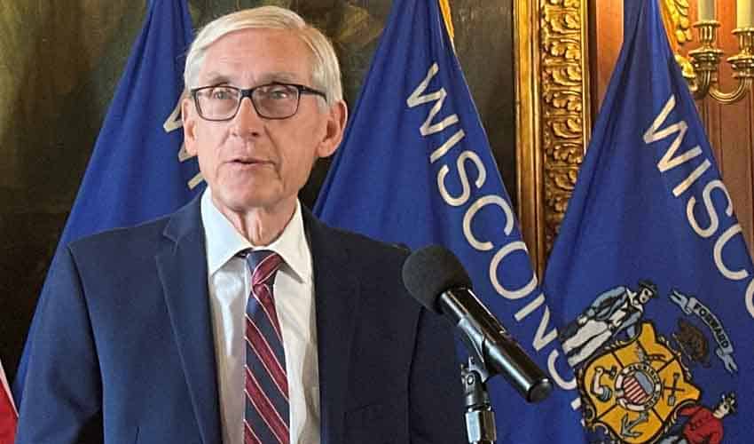 WI Gov. Evers speaking to the press at his official podium