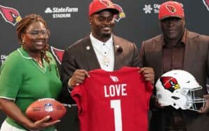 Jeremiyah Love and his parents after being drafted by the Cardinals
