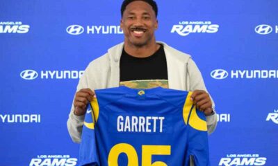 Myles Garrett holding up his Rams jersey