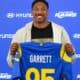 Myles Garrett holding up his Rams jersey