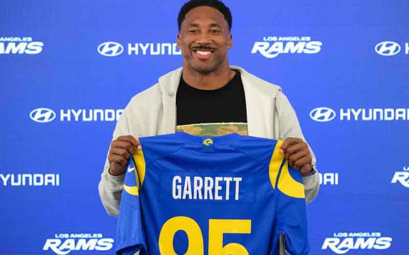 Myles Garrett holding up his Rams jersey