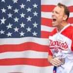 Joey Chestnut celebrating in front of a US flag