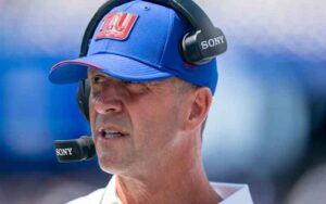 Man wearing a blue NY cap with Sony headset and microphone, speaking during a game or broadcast
