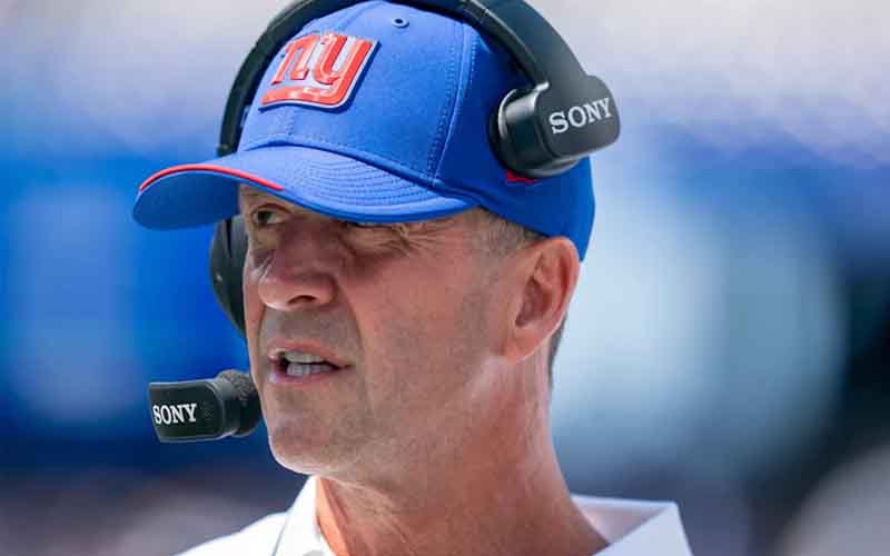 Man wearing a blue NY cap with Sony headset and microphone, speaking during a game or broadcast
