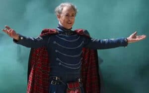 The Traitors host Alan Cumming spreading his arms